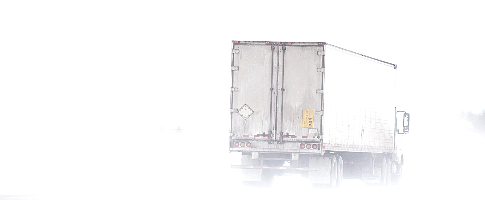 trucking in winter snow icy black ice united states and canada tips, image of a semi truck